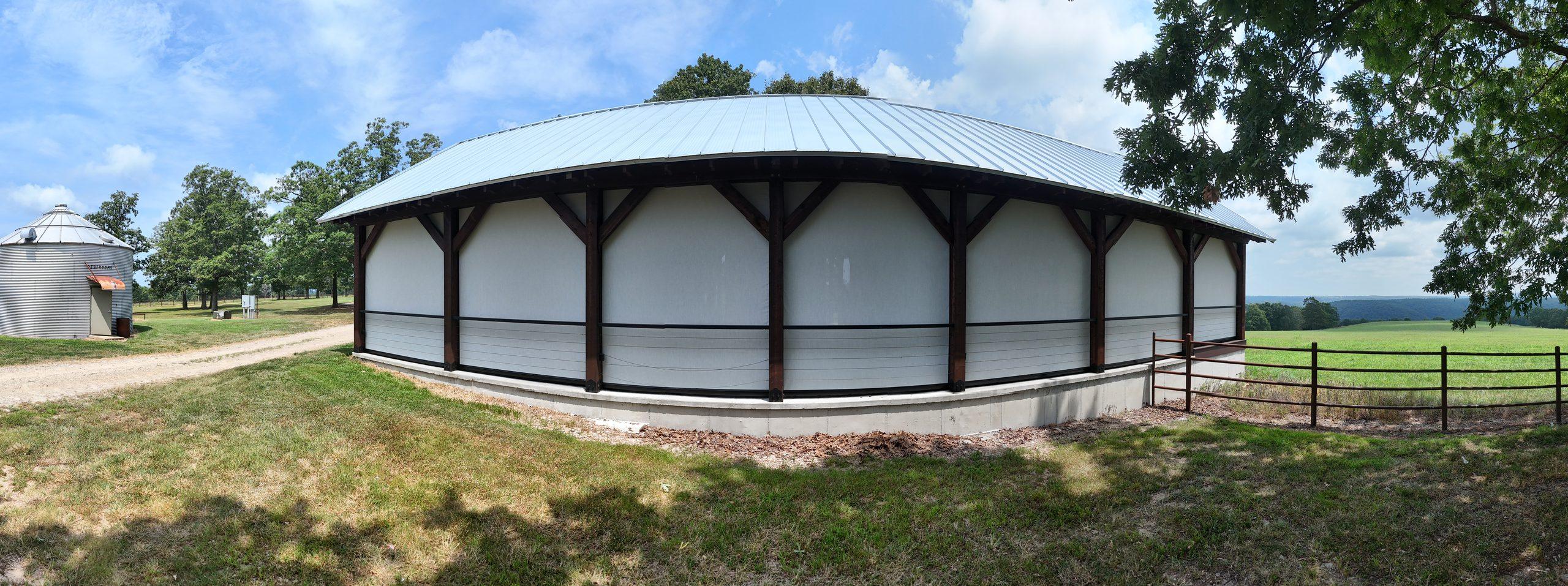 Side view of a large outdoor pavilion in Tilly, Arkansas with floor-to-ceiling motorized screens fully deployed, custom screen enclosure installation by NWA Security Shutters